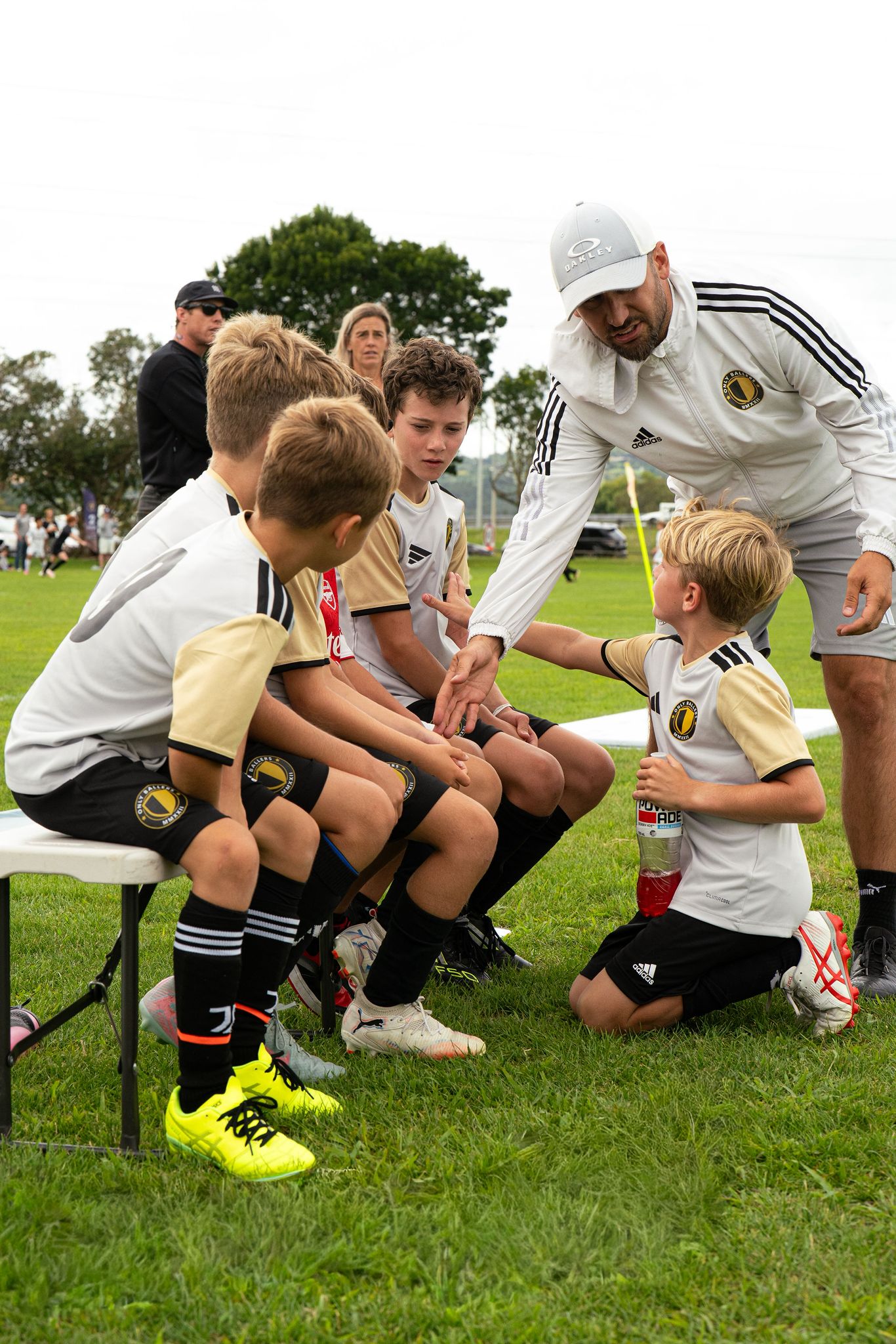 Coach talking to players on the bench
