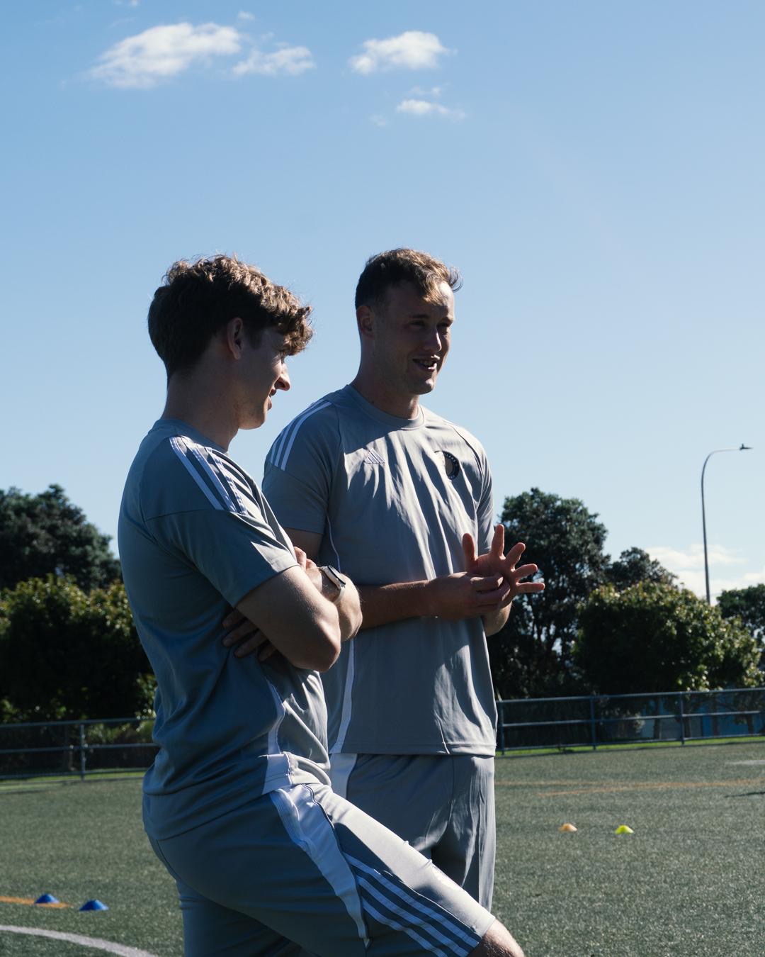 Coaches Mitch and DG discussing on pitch