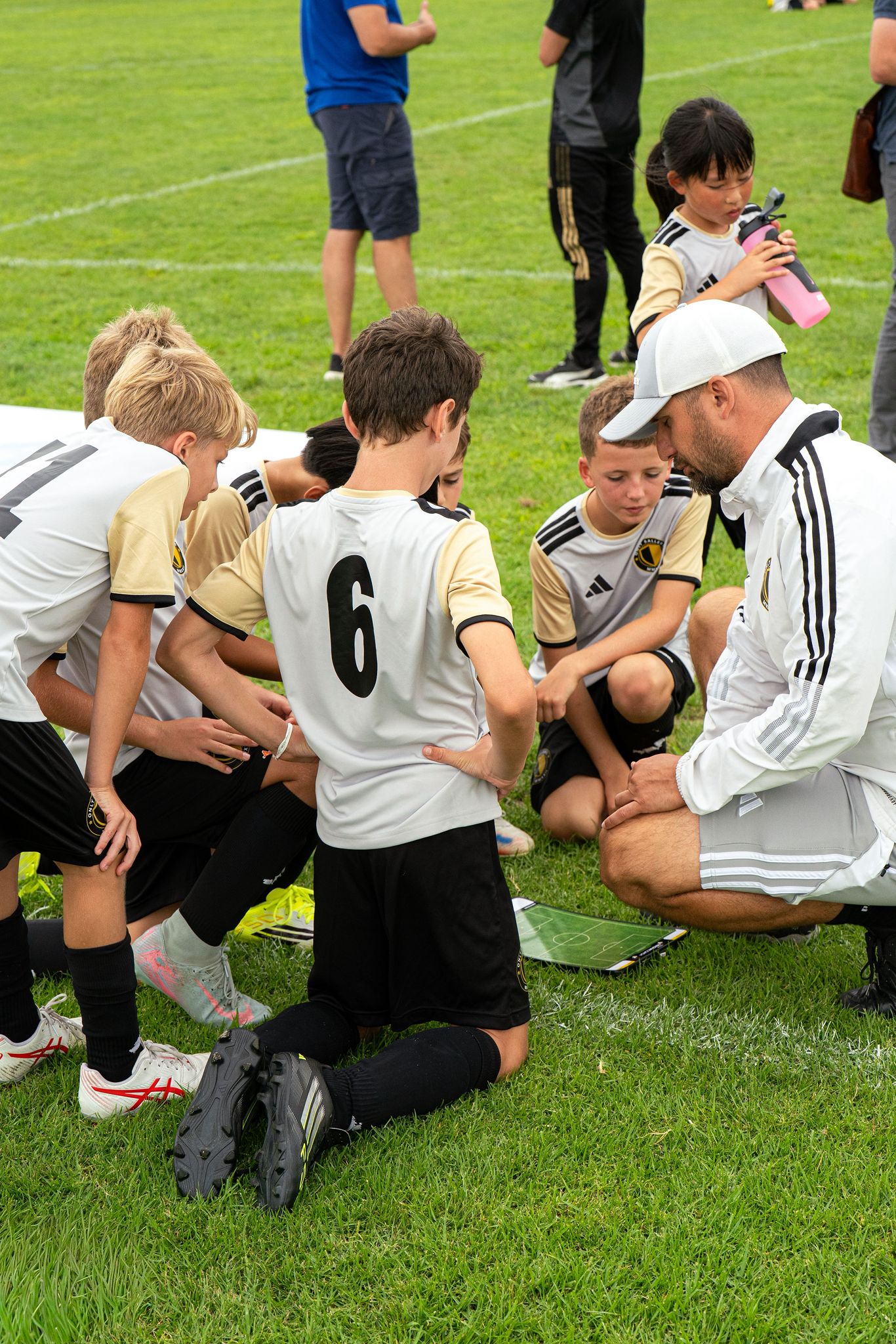 Coach kneeling with tactical board