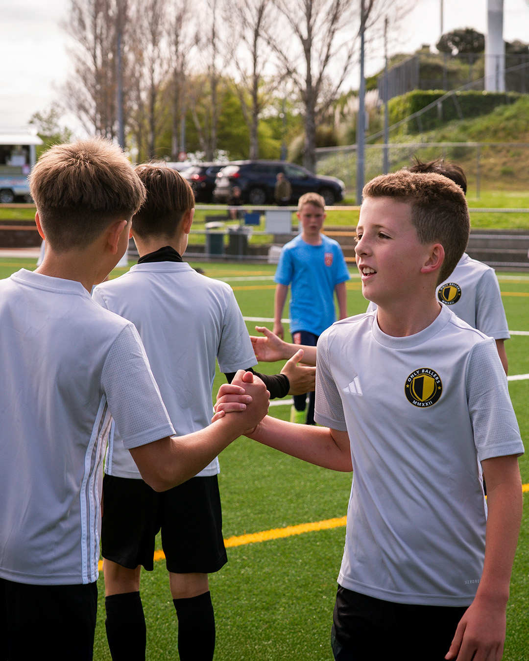 U10 players showing sportsmanship with pre-match handshakes